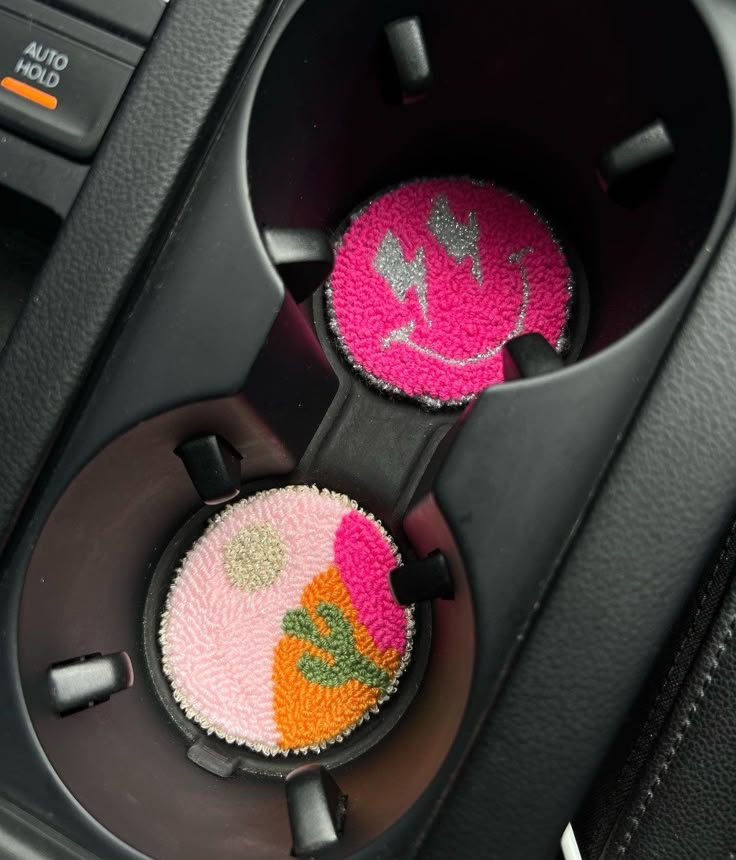 two car air fresheners sitting in the center console