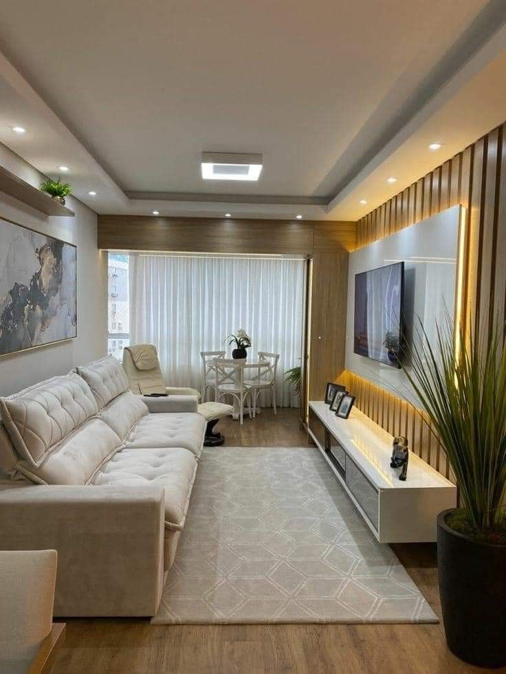 a living room filled with furniture and a flat screen tv