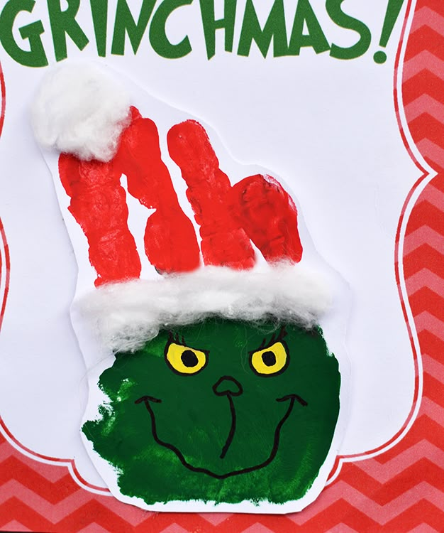 the grinchmas handprint is on top of a red and white paper plate