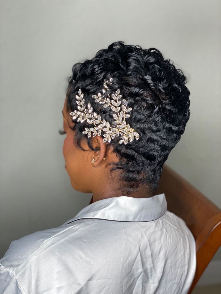 a woman sitting in a chair wearing a hair comb with leaves on it's back