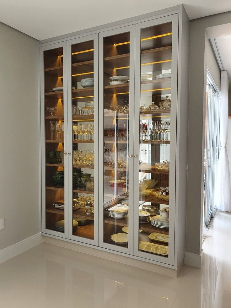 an empty room with glass doors and shelves full of food