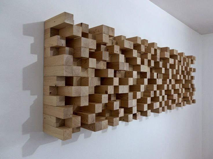 a wall sculpture made out of wooden blocks