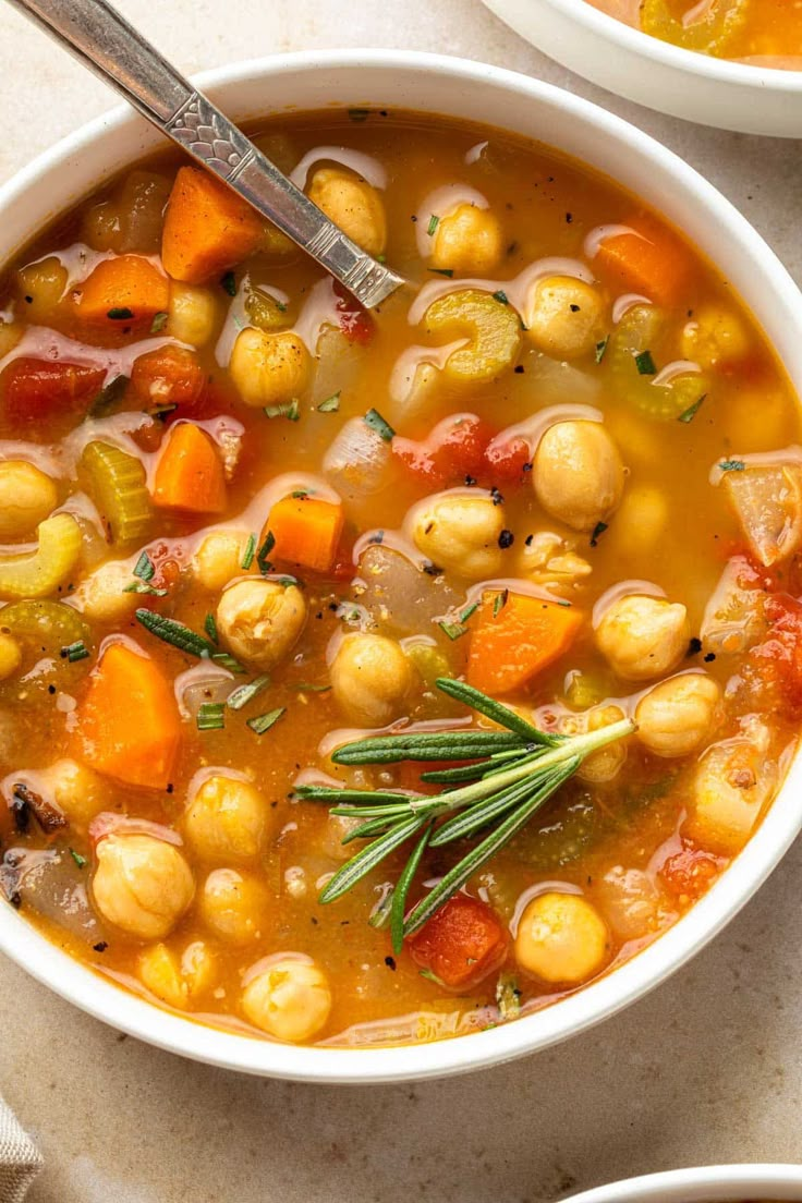 two bowls of vegetable soup on a table