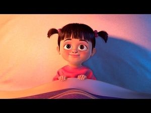 a cartoon character with big eyes sitting on top of a bed in front of a pink wall