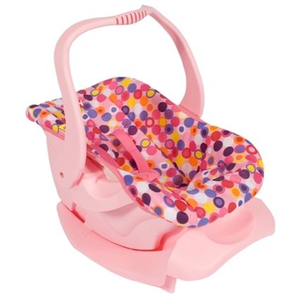 a pink baby seat with colorful polka dots on the front and back, attached to a handle