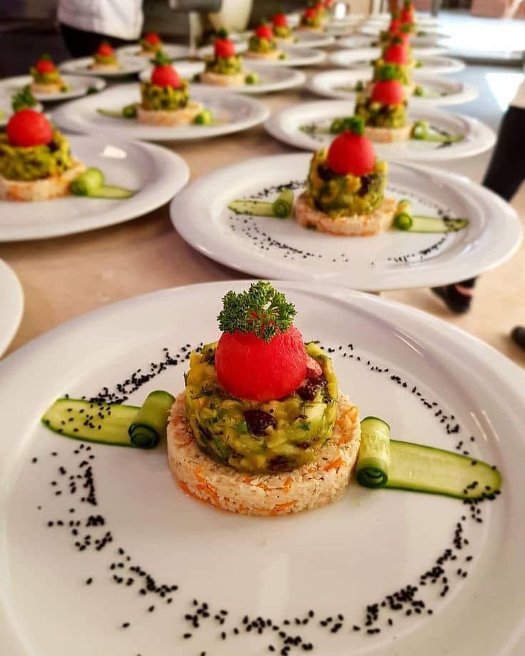 small appetizers on white plates with cucumber and tomato garnish