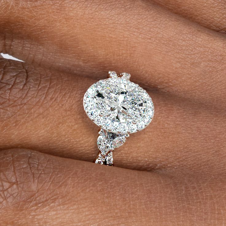 a woman's hand with a diamond ring on it