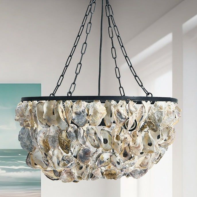 a chandelier made out of seashells hangs from a ceiling in a room