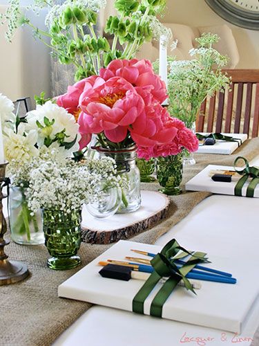 the table is set with flowers, candles and napkins for guests to place on