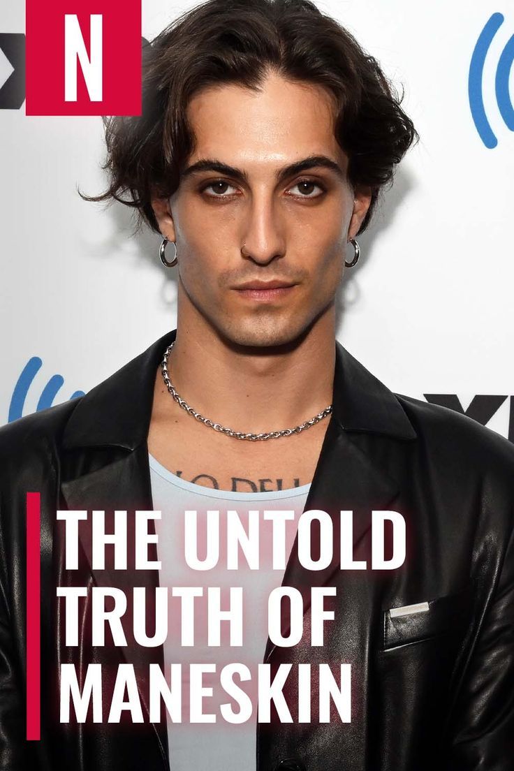 a man with long hair and piercings standing in front of a sign that says the unto truth of manskin