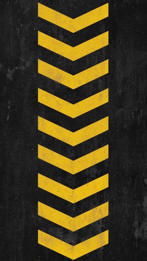 a black and yellow poster with an arrow on it's left side in the center