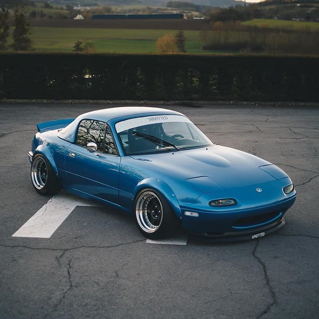 a blue sports car parked in a parking lot