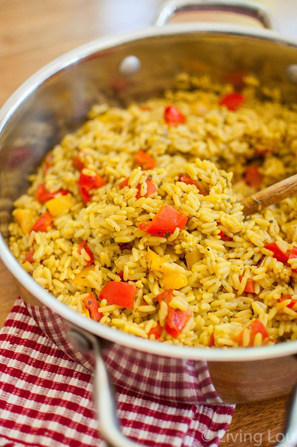 a pot filled with rice and vegetables on top of a table