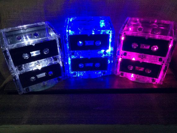 three different colored cassettes sitting on top of a table