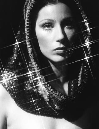 black and white photograph of a woman wearing a scarf with stars in the sky above her head