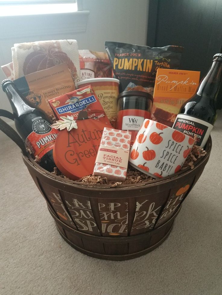 a basket filled with lots of different types of food and drinks sitting on top of a carpeted floor