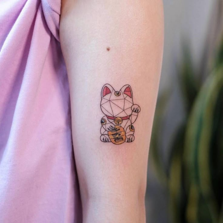 a cat tattoo on the left arm and right arm with an origami design