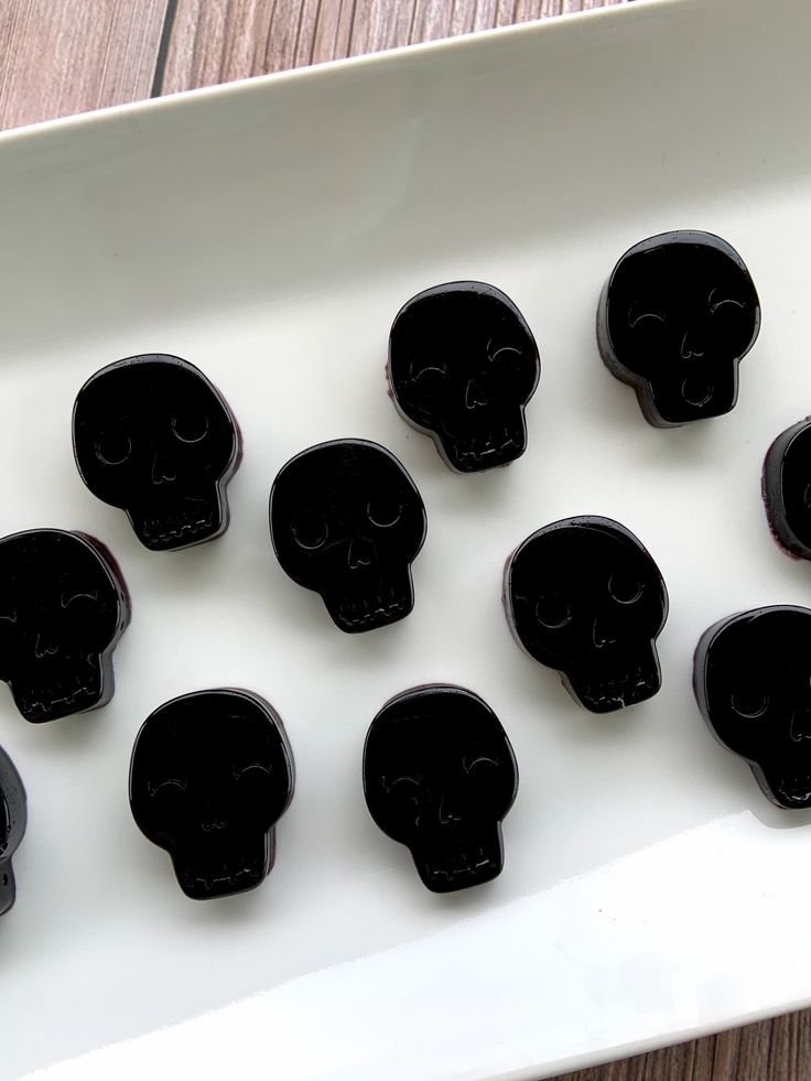 black sugar skulls sitting on top of a white plate