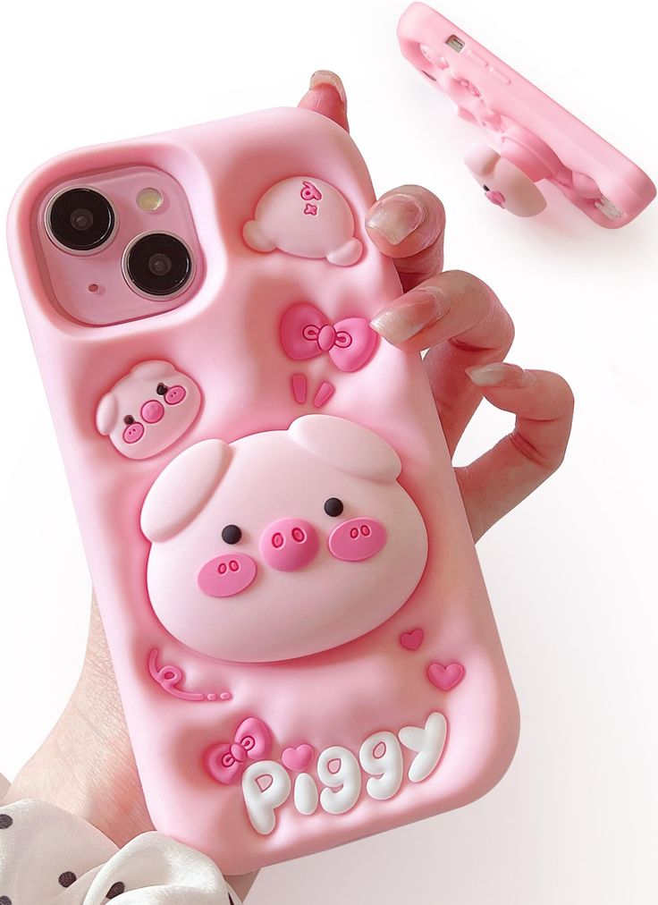 a hand holding a pink phone case with pigs on it and the words pigy written in cursive writing