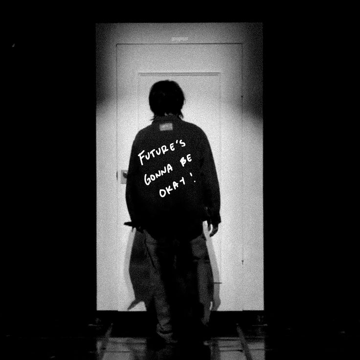 a man standing in front of a door with writing on his jacket that says future's gonna be okay