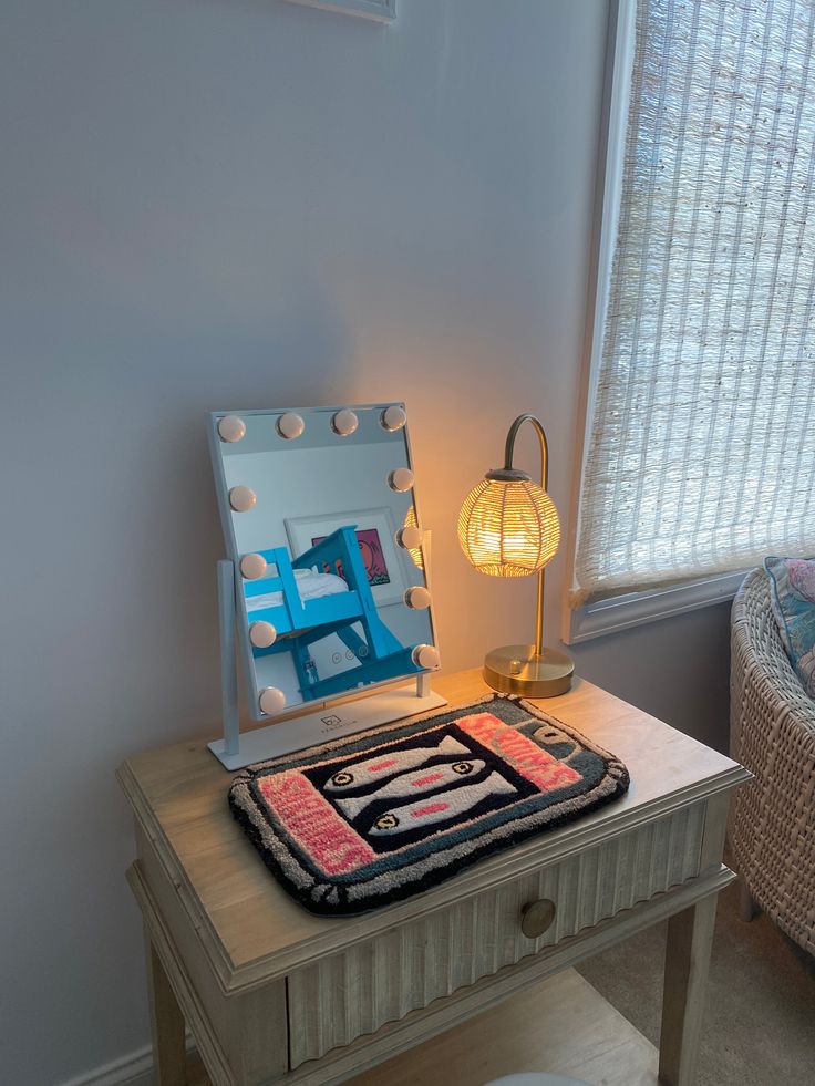 a table with a mirror and lamp on it