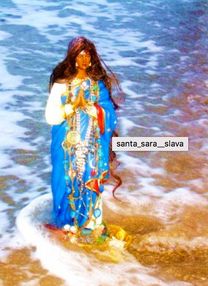 a woman standing in the water at the beach