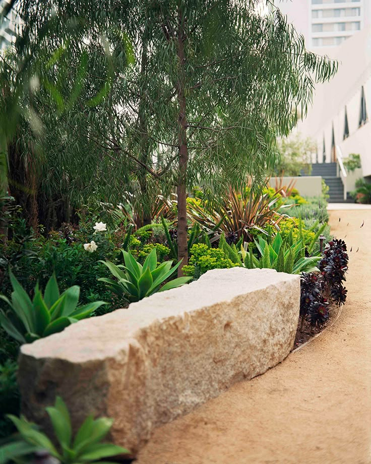 a stone bench sitting in the middle of a garden