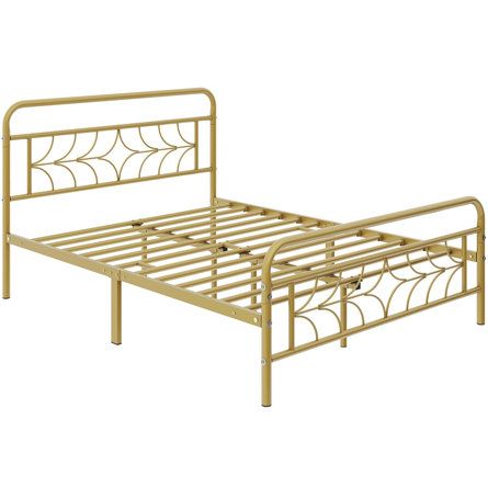 a gold metal bed frame with an intricate design