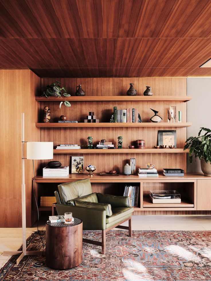 a living room filled with furniture and wooden shelves