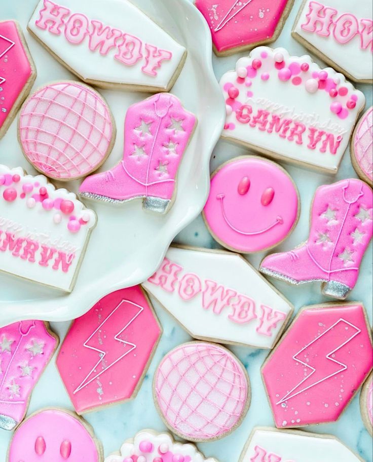 pink and white decorated cookies on a plate