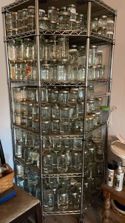 a large metal rack filled with lots of glass jars