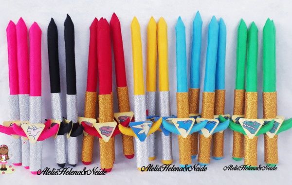 several different colored pens lined up next to each other on a white surface with gold trim