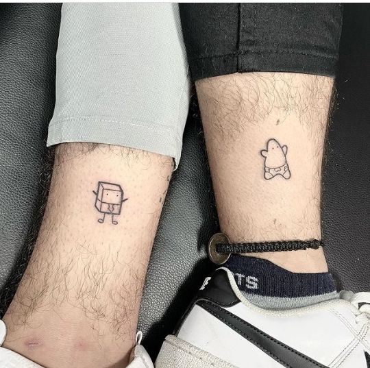 two people with matching tattoos on their legs