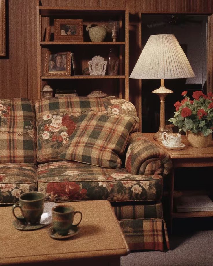 a living room with plaid furniture and flowers on the table