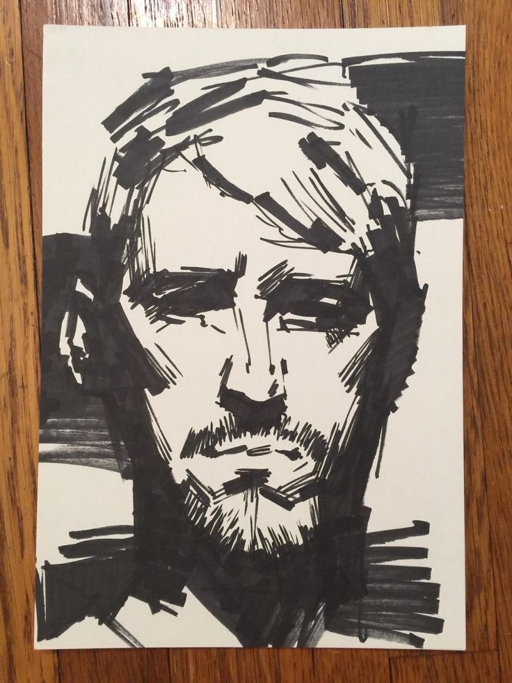 a black and white drawing of a man's face on a piece of paper