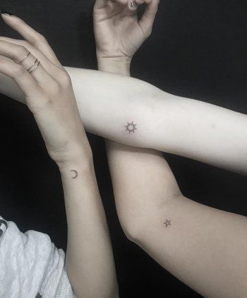 two people with matching tattoos on their arms