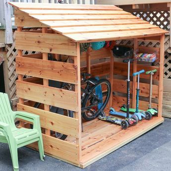 a small wooden shed with a bicycle in it