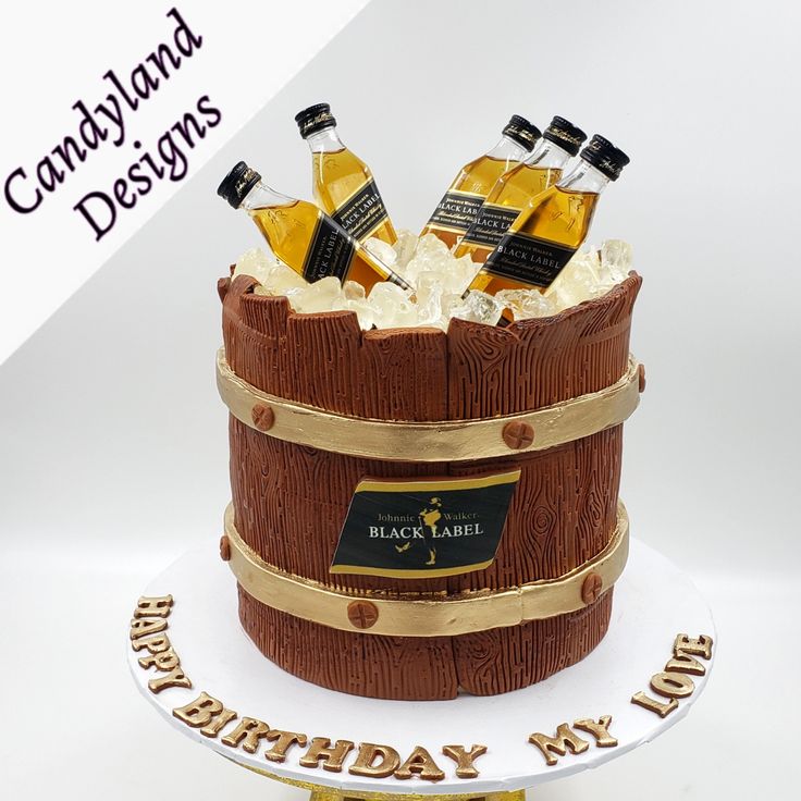 a birthday cake that is made to look like a barrel with wine bottles in it