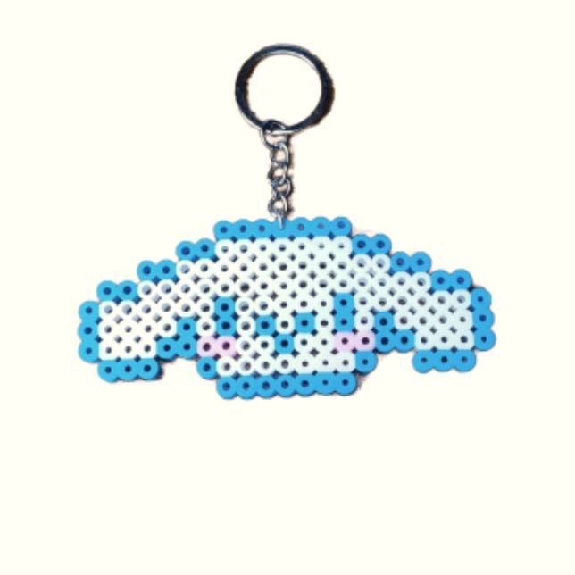 a keychain with an image of a cloud on it's front and back sides