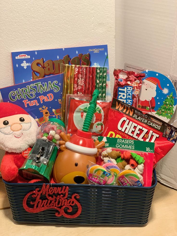 a christmas gift basket filled with candy, candies, and other holiday goodies