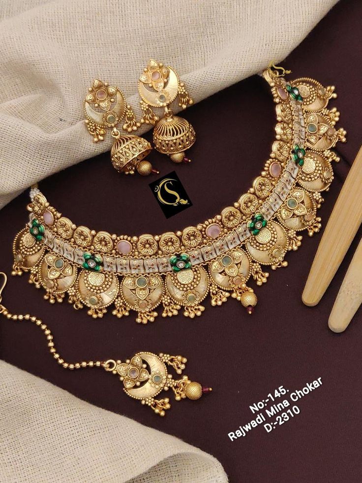 Description :- Beautiful Stylish choker/long matte golden necklace set/south indian wedding necklace with earrings/Traditional Temple Jewellery WEDDING Necklace Set, Wedding Necklace Set, Gold Plated Indian Jewelry Set, Necklace Earring Set, Party Wear Set, Indian Necklace Set Gift yourself a royal look with this perfectly crafted kundan necklace set from Manalisstudio. Crafted with high quality kundan stones and pearls, it is impressive in design. The green enamel artwork adds perfect texture t Luxury Bridal Necklace For Puja With Intricate Design, Golden Jewellery Set, Gold Jewellery Set Design, Chandbali Kundan Necklace For Marriage, Kundan Meenakari Necklace For Marriage, Heavy Chandbali Kundan Necklace For Marriage, Gold Necklace Set Bridal, Traditional Gold Bridal Necklace With Dual-tone, Traditional Hand-set Yellow Gold Bridal Necklace