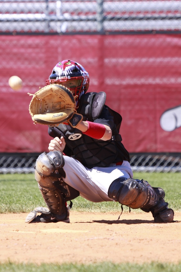 a baseball player catching a ball with his glove