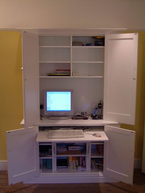 a computer monitor sitting on top of a white desk