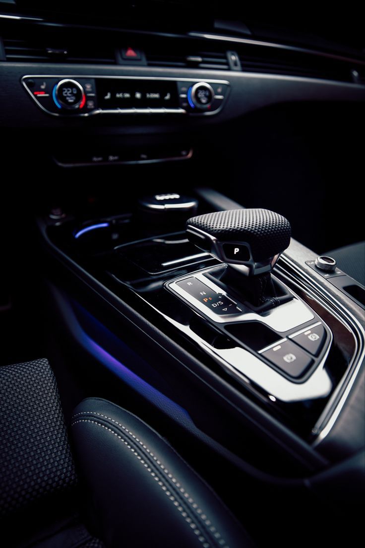 the interior of a car with an automatic gear box and control knobs on it