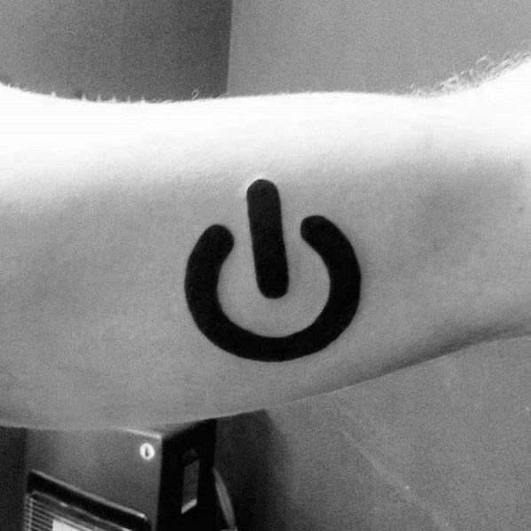 a black and white photo of a person's arm with a power button tattoo on it