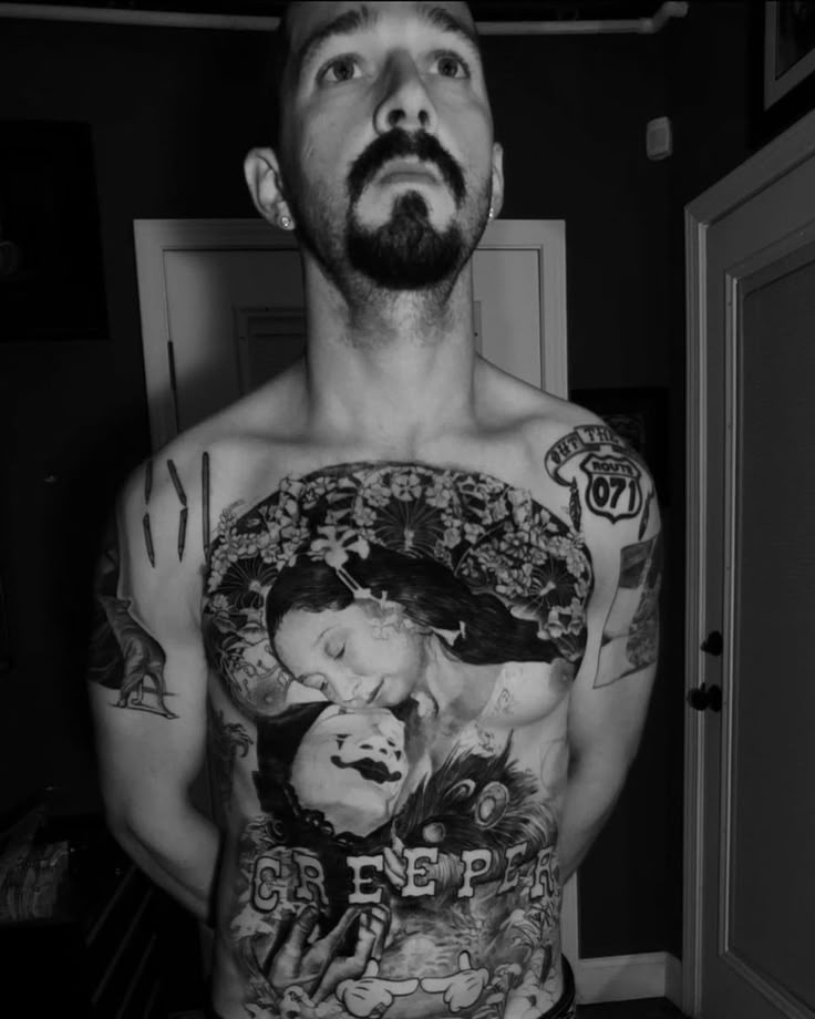 a man with many tattoos on his chest