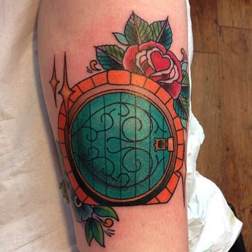 a woman with a tattoo on her arm has a clock and roses around the window