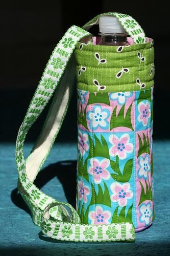 a green and pink flowered water bottle holder