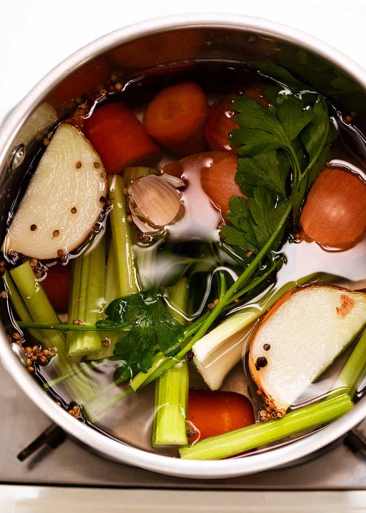 a pot filled with vegetables on top of a stove