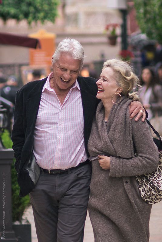 an older couple walking down the street together